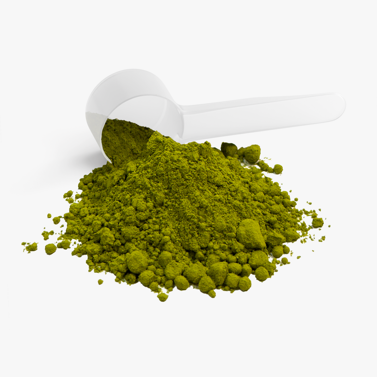 Green matcha powder spilling out of a white scoop on a white background