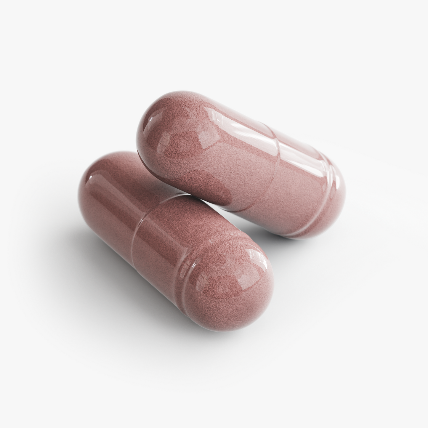 Two pink capsules on a white background