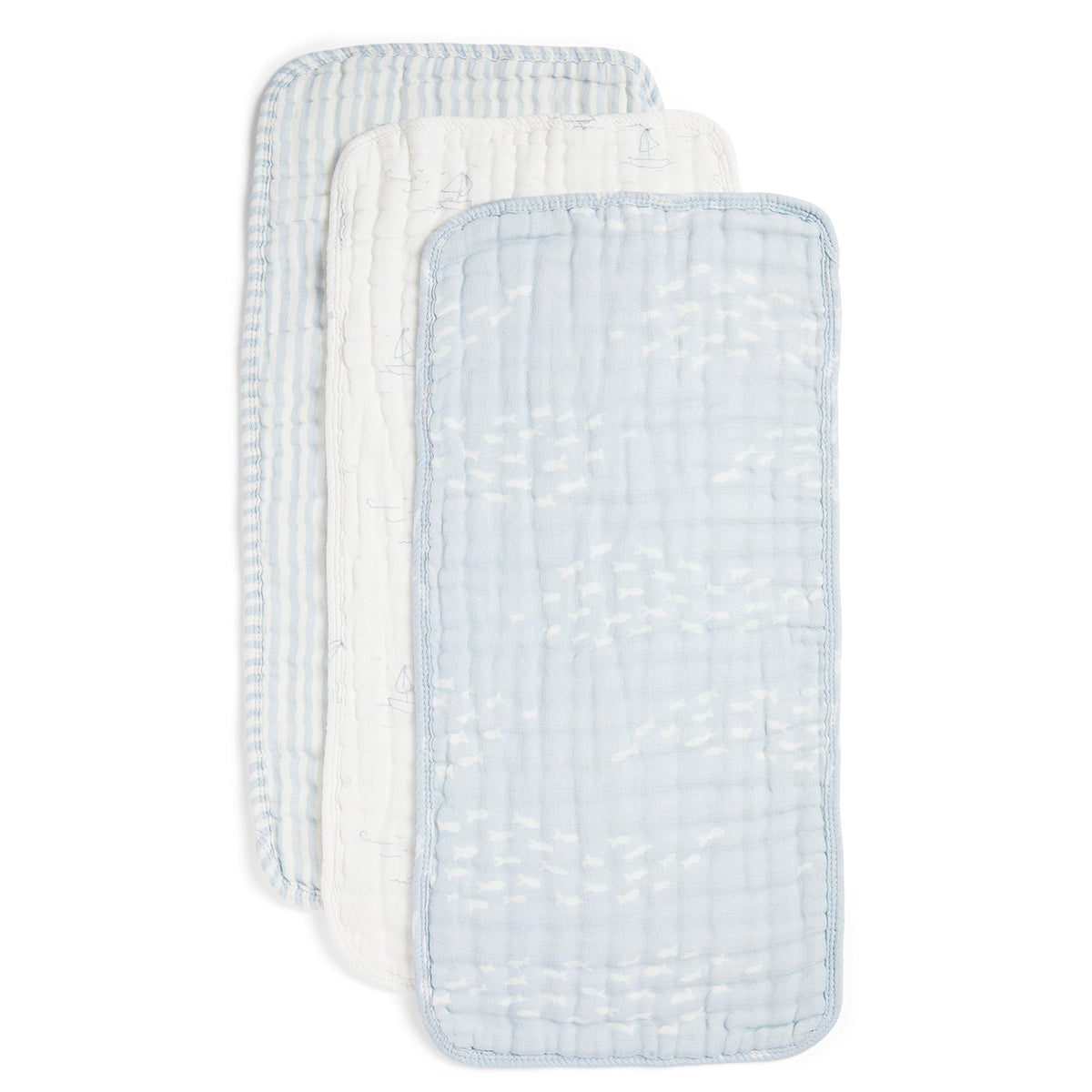 Three reusable muslin baby wipes stacked diagonally, featuring a light blue and white patterned front wipe and two white wipes with light blue stripes behind it, on a solid white background.