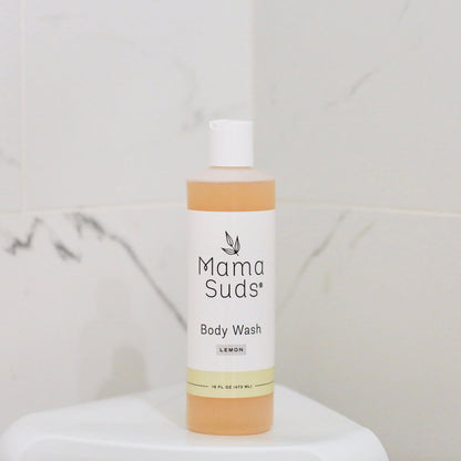 Mama Suds body wash bottle on a white surface with a light gray background