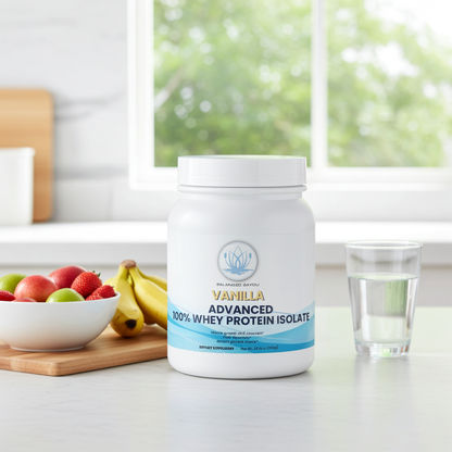 A white tub of Vanilla 100% Whey Protein Isolate stands on a kitchen counter beside a glass of water, with a bowl of fruit and a window in the background.