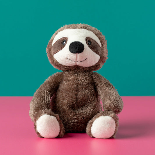 Plush sloth toy on a pink surface with a teal background