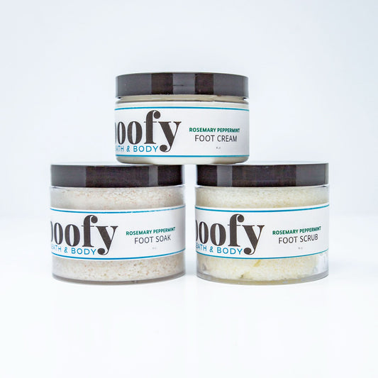 Three jars of 'noofy' foot care products arranged in a pyramid on a white background: a top jar of Rosemary Peppermint Foot Cream, a bottom-left jar of Foot Soak, and a bottom-right jar of Foot Scrub.