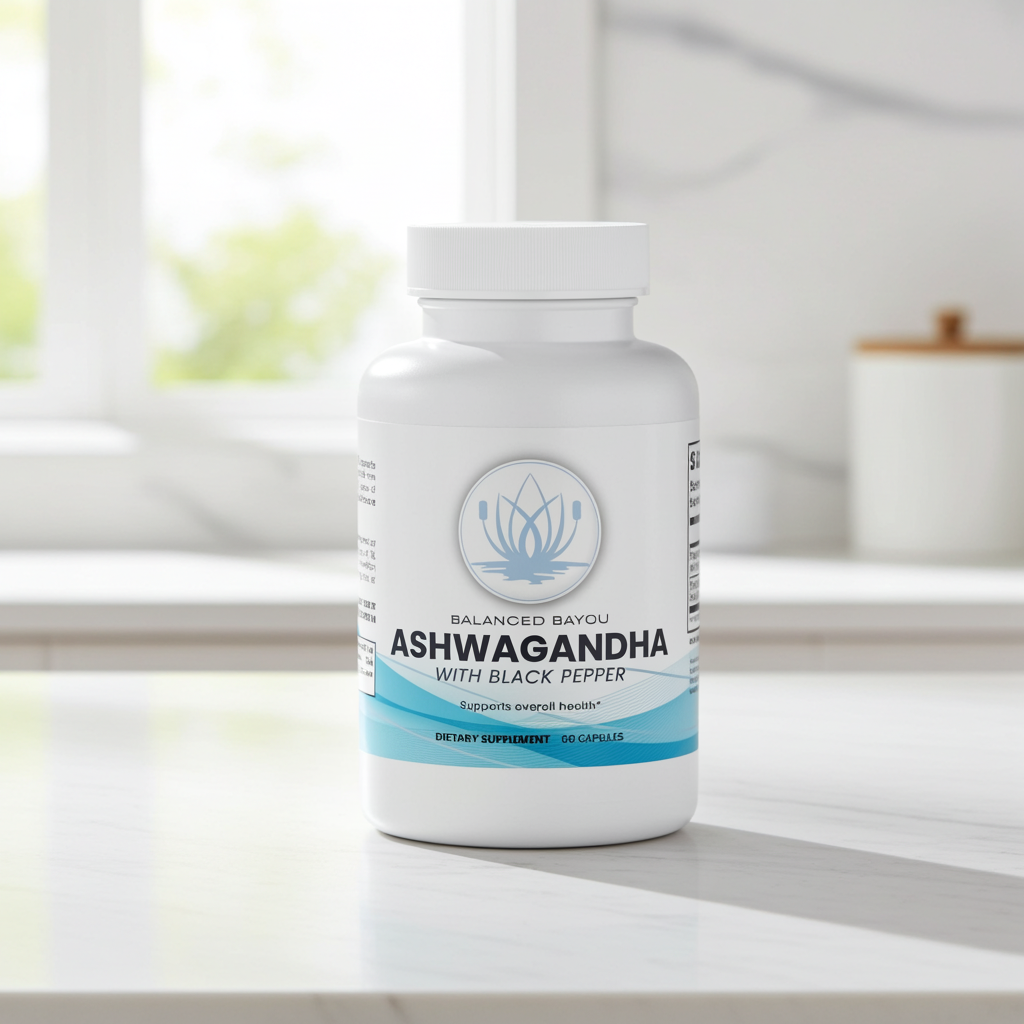 A white bottle of Balanced Bayou Ashwagandha with Black Pepper dietary supplement, placed on a light marble countertop in a bright kitchen setting.