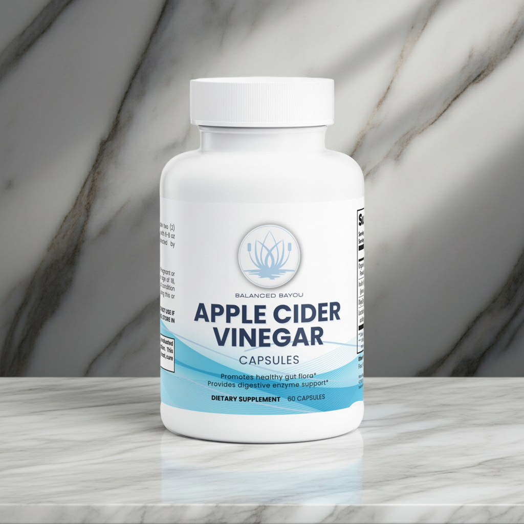 A white bottle of Balanced Bayou Apple Cider Vinegar Capsules, set on a light marble surface with a matching marble background.